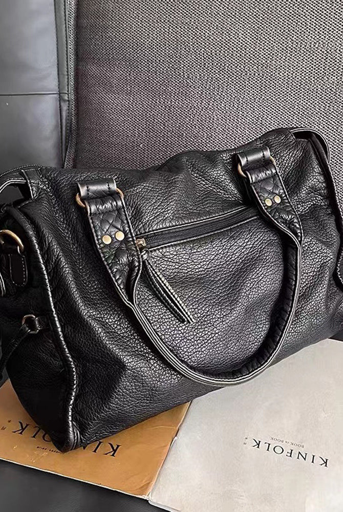 Victoria Lumina black PU leather handbag with multiple pockets, stylish design, and sleek handles for versatile everyday use.