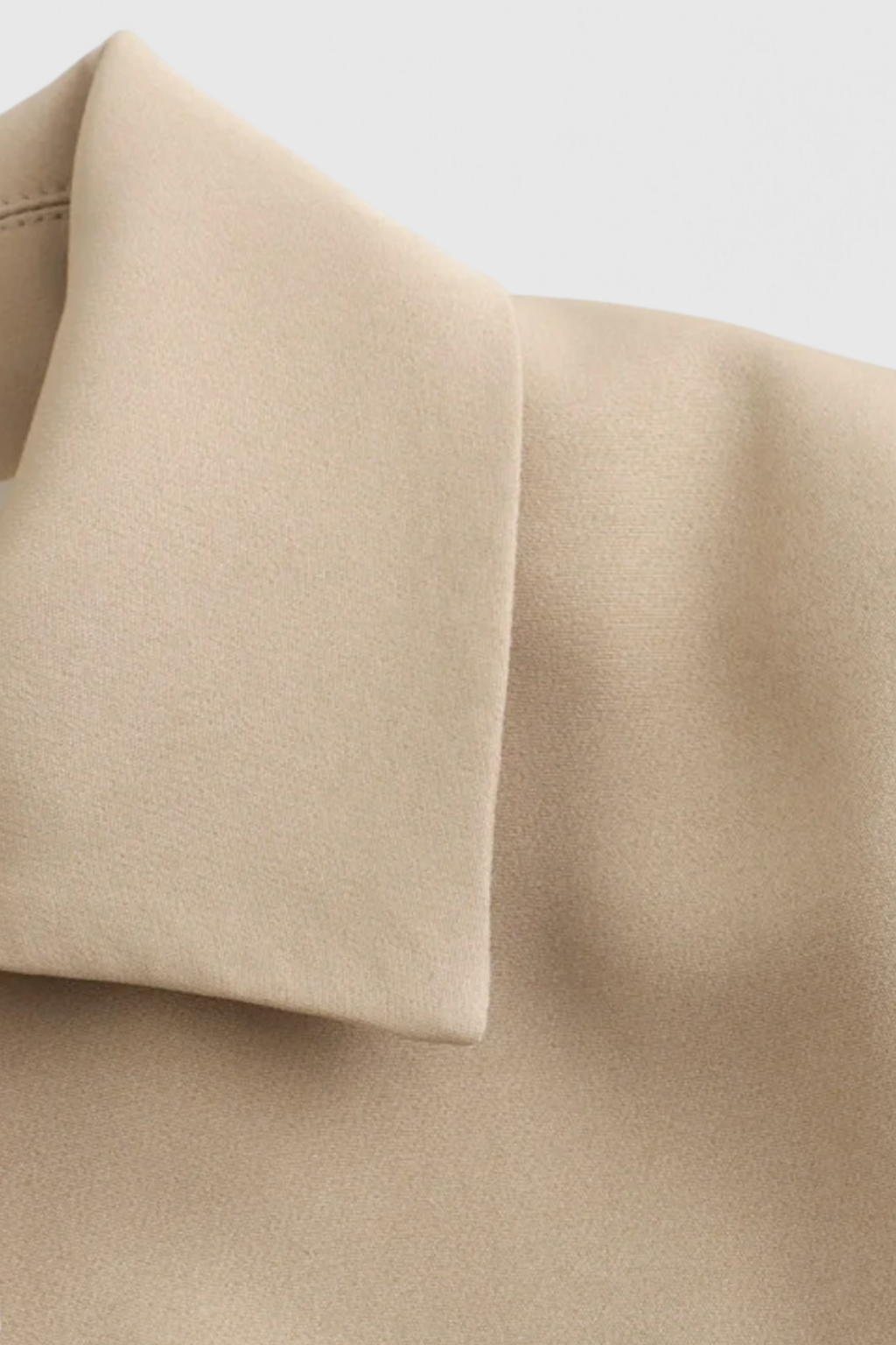 Khaki Victoria Lumina Wear cropped button jacket with a flattering fit, shown on a model. Stylish and modern outerwear.