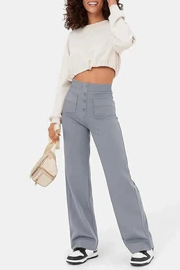 Victoria chic high-waisted trousers by Lumina Wear in stone green with stretch fabric, shown on a model.