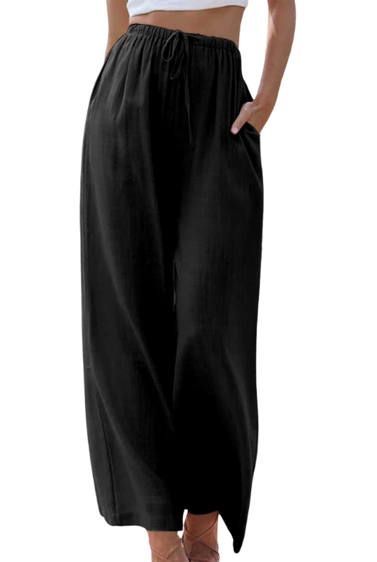 Victoria Lumina Wear black wide-leg trousers with a loose fit, shown on a model, highlighting stylish, comfortable fashion.