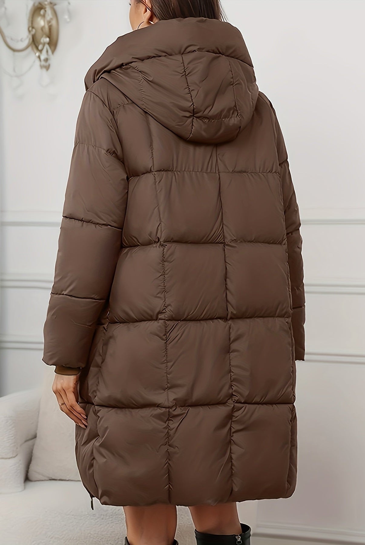 Redish-brown Lumina Wear Victoria cozy longline hooded puffer coat with practical pockets, shown on a model outdoors.