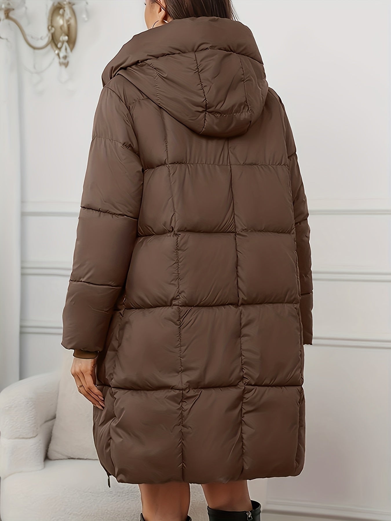 Redish-brown Lumina Wear Victoria cozy longline hooded puffer coat with practical pockets, shown on a model outdoors.