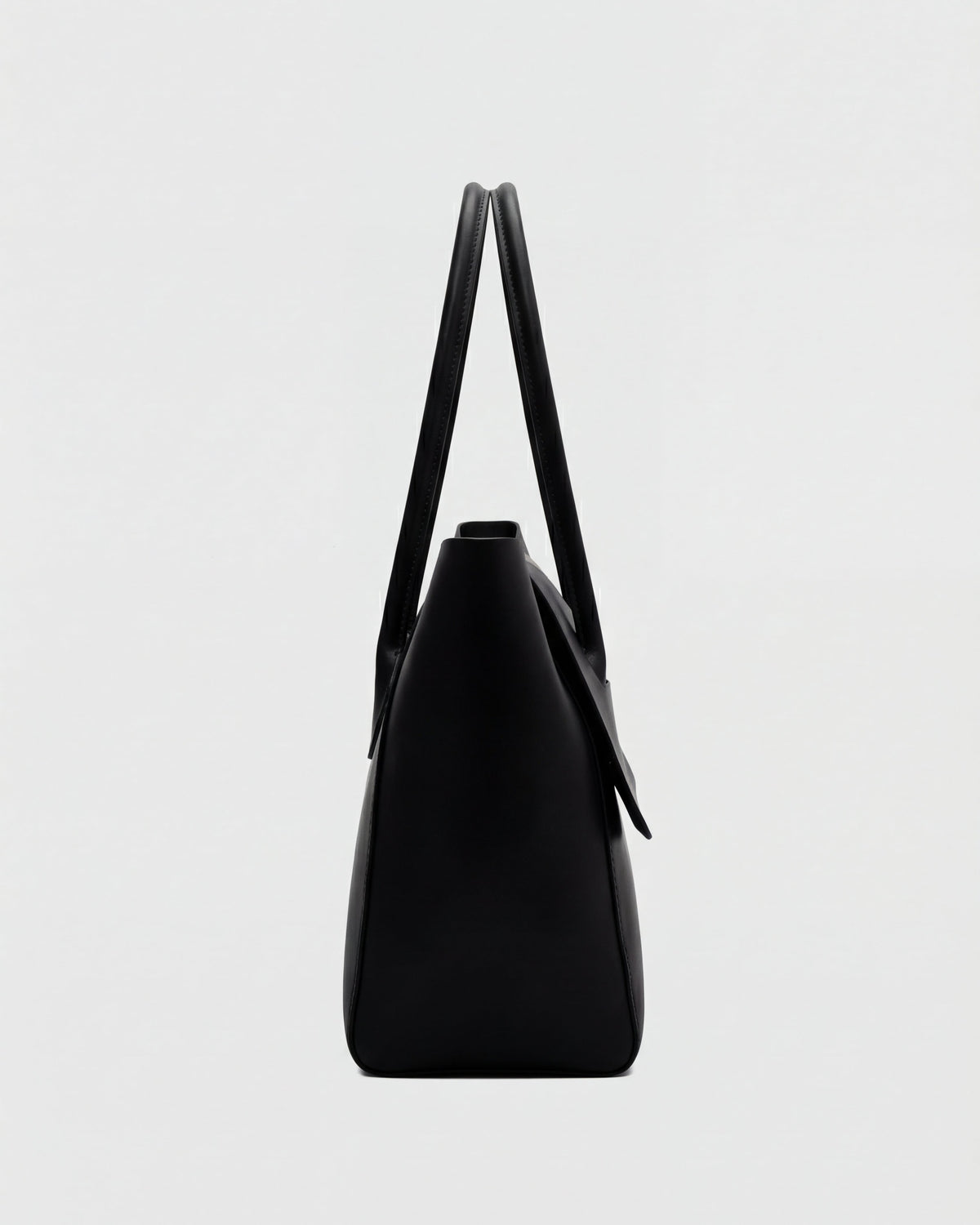 Elegant black Lumina Wear handbag with adjustable strap, showcasing sleek design and stylish carry options.