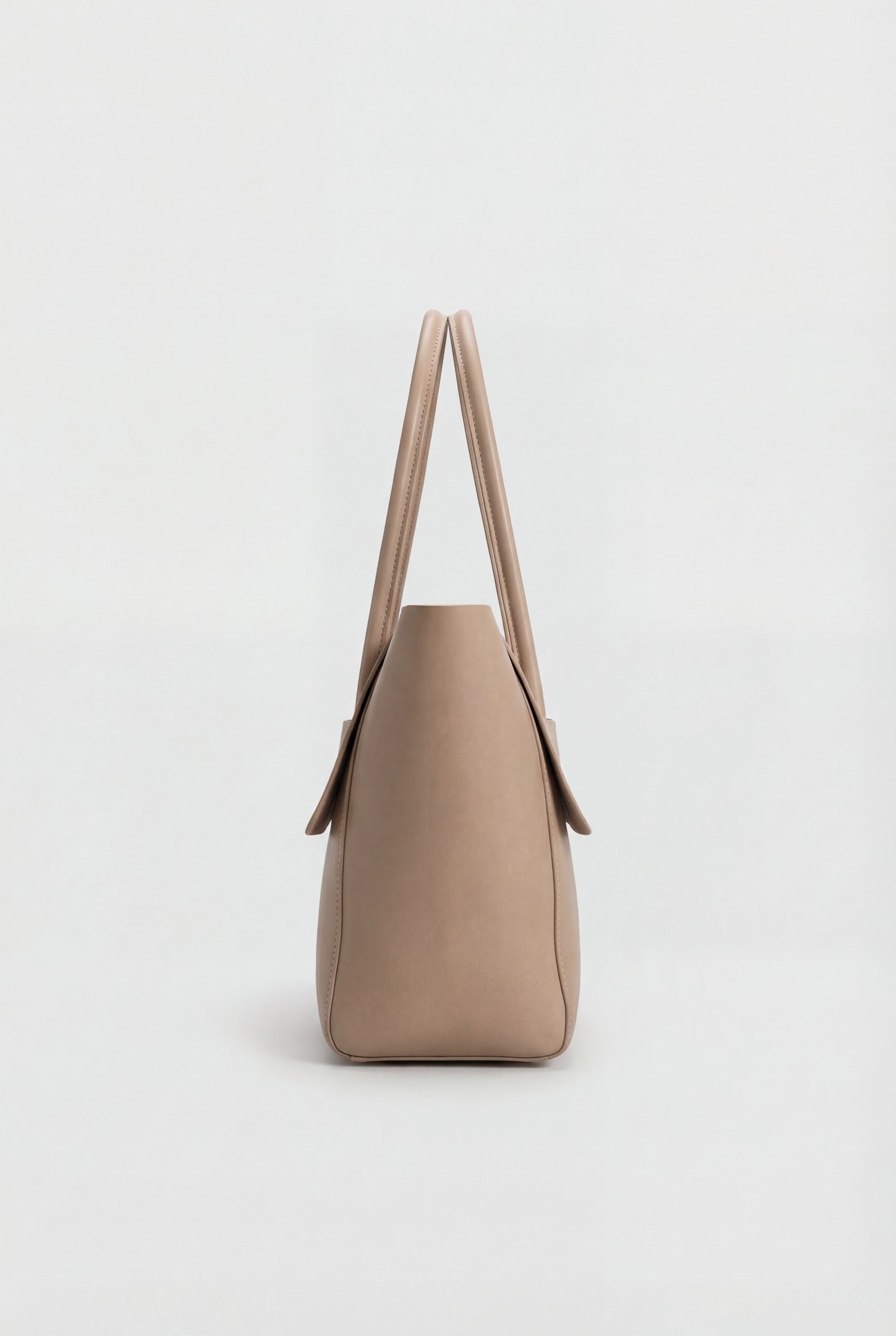 Elegant black Lumina Wear handbag with adjustable strap, featuring a sleek design and stylish handles for versatile use.