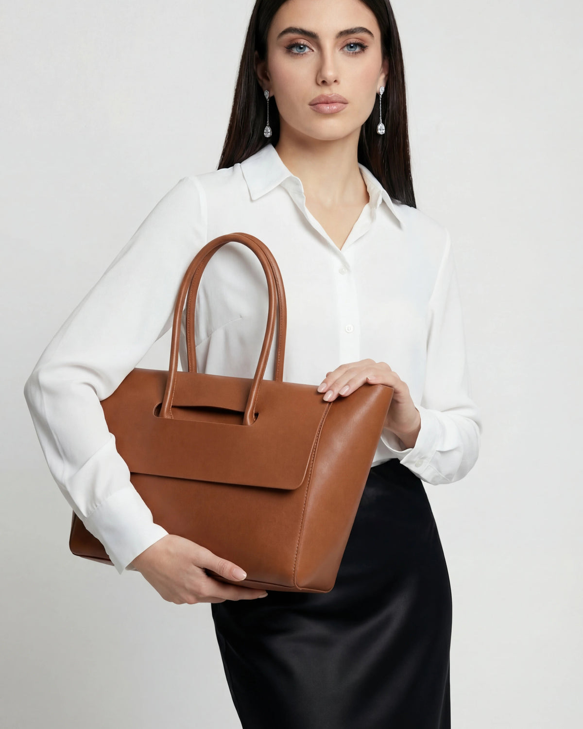 Elegant black Lumina Wear Victoria handbag with adjustable strap, featuring a sleek design and spacious interior.