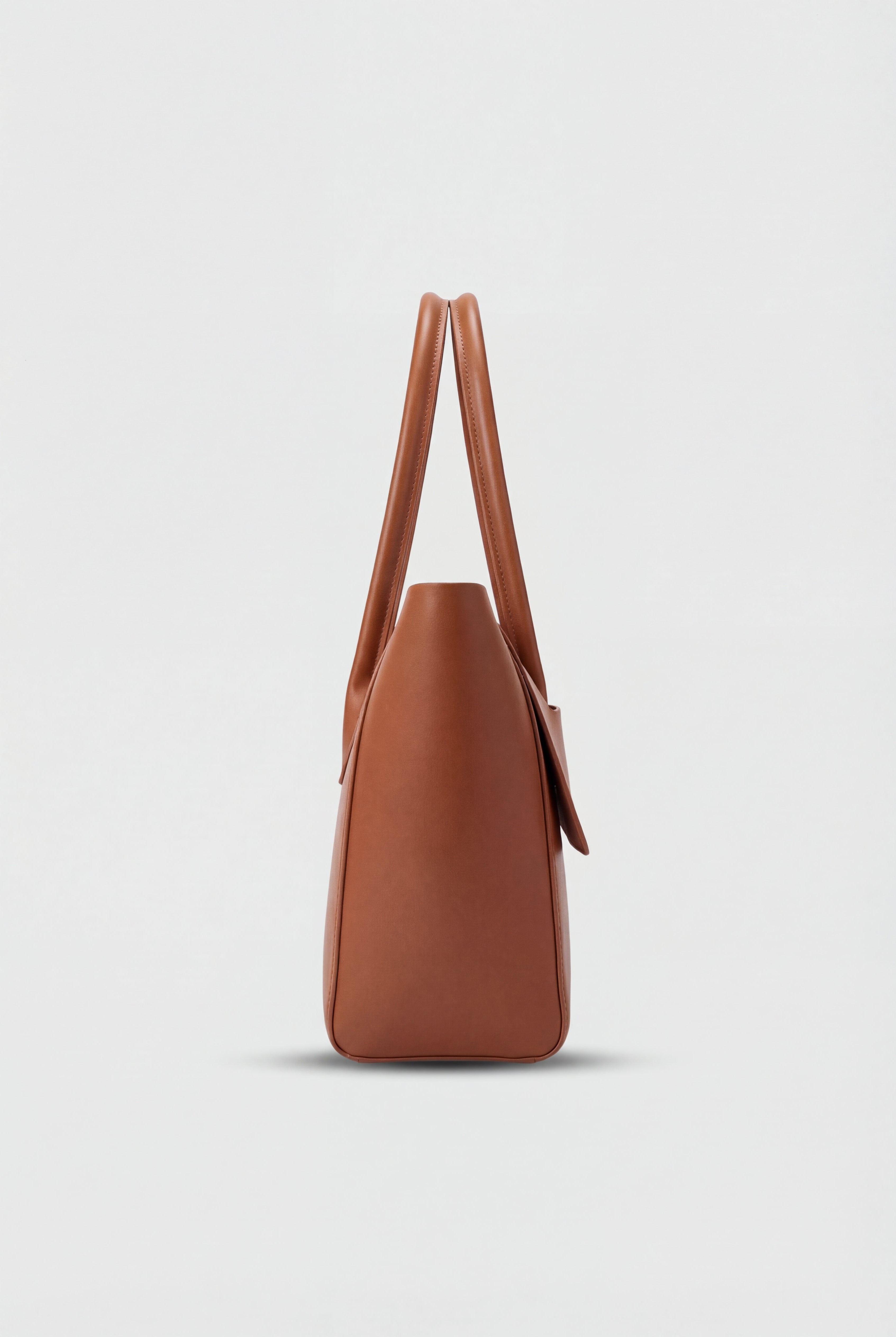 Elegant black Lumina Wear handbag with adjustable strap, featuring a sleek design and stylish handles for versatile use.