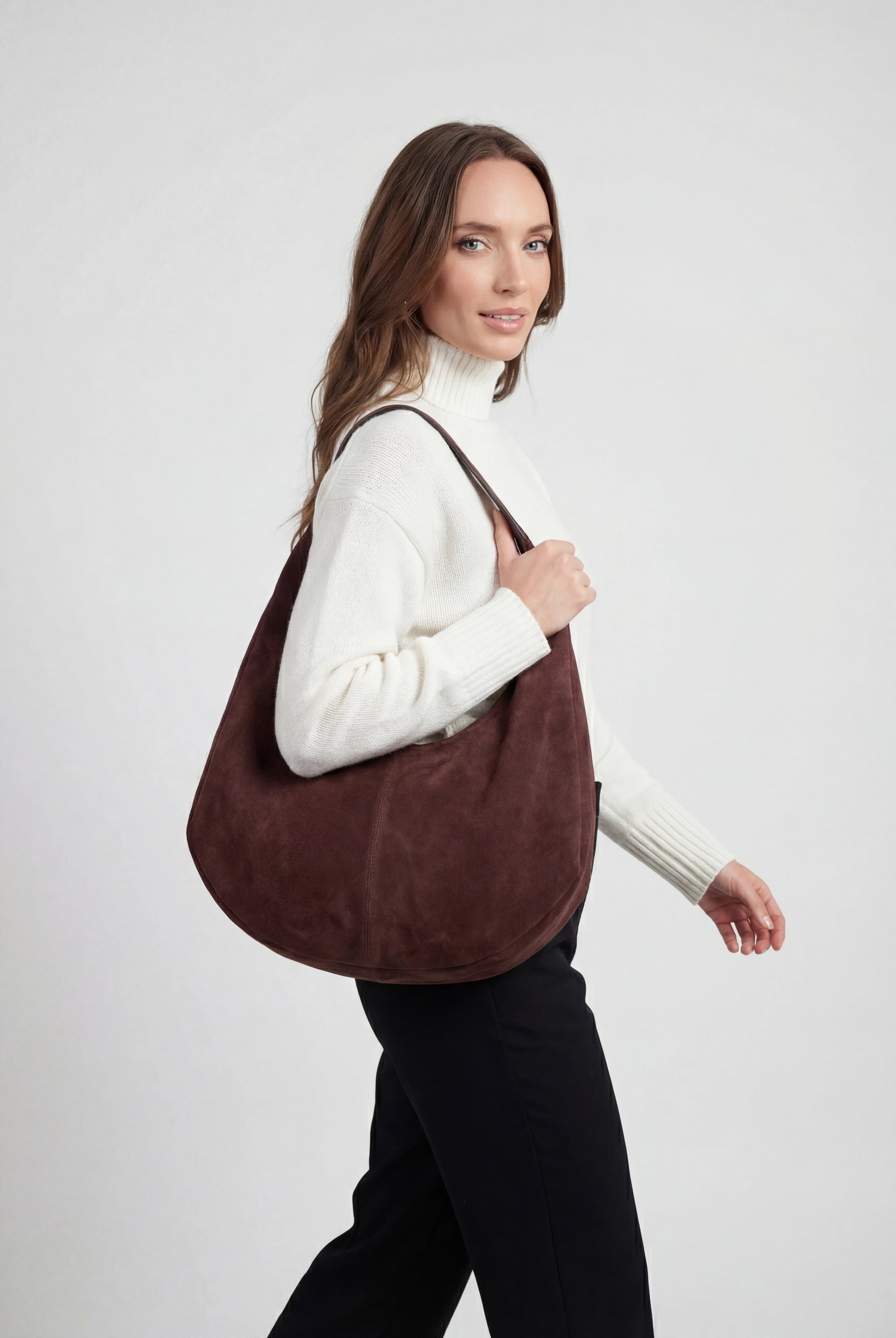 Elegant black suede hobo handbag by Lumina Wear with multiple pockets, featuring a stylish and spacious design.
