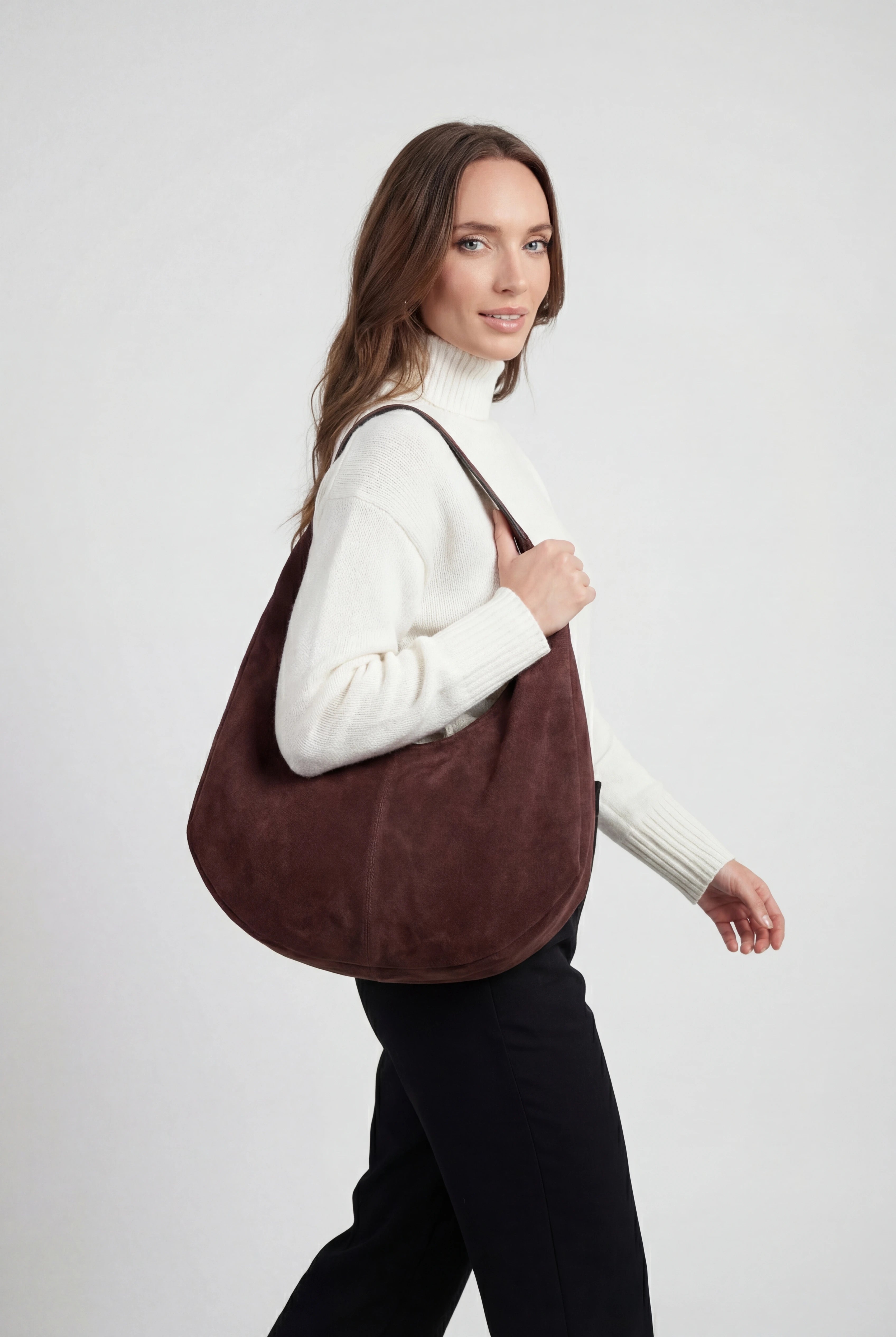 Elegant black suede hobo handbag by Lumina Wear with multiple pockets, featuring a stylish and spacious design.
