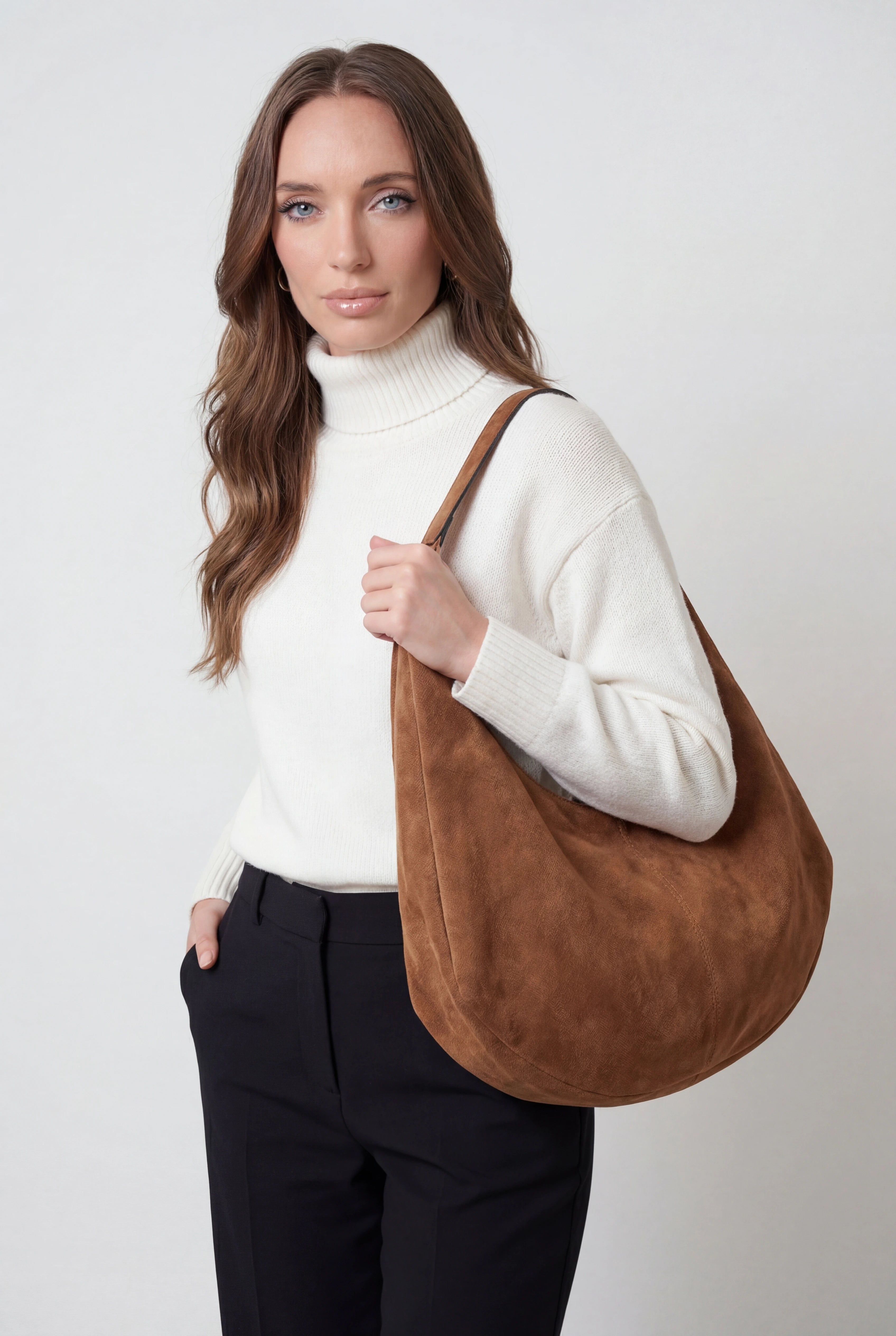 Elegant black suede hobo handbag by Lumina Wear with multiple pockets, showcasing a stylish and functional design.