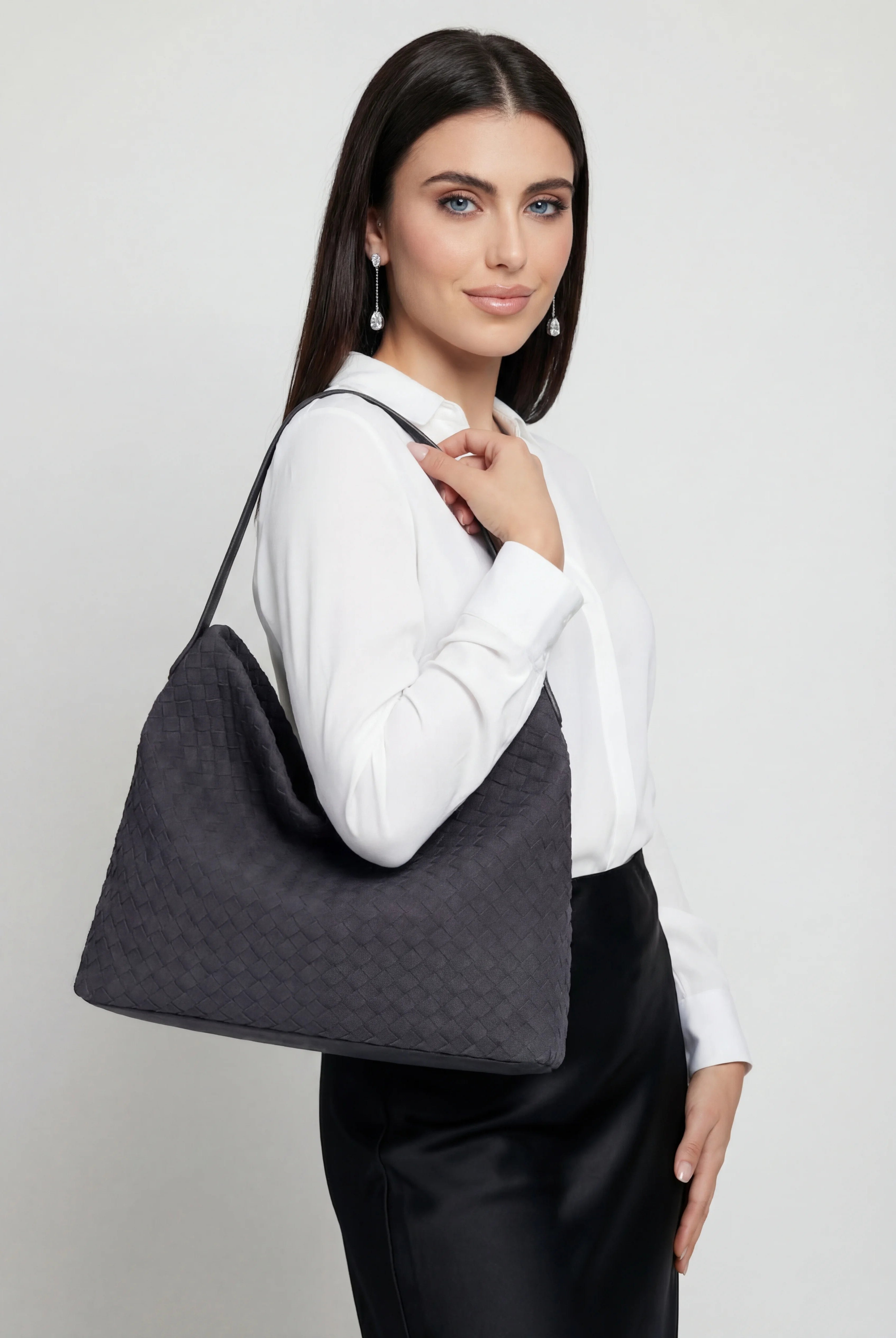 Elegant black suede tote bag by Lumina Wear, featuring a spacious design and stylish craftsmanship for everyday use.
