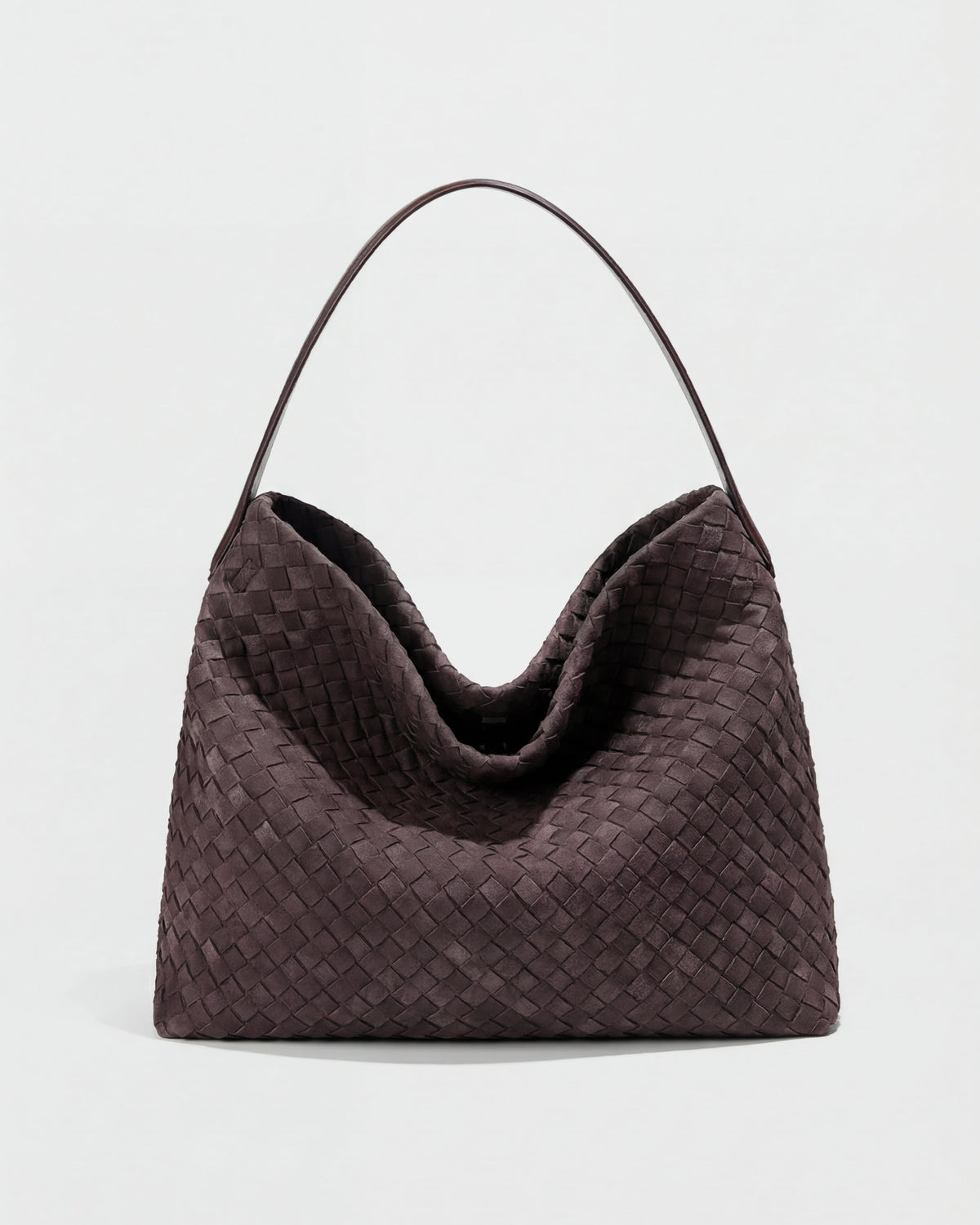 Elegant black suede tote bag by Lumina Wear featuring a spacious design and structured hand-held style.