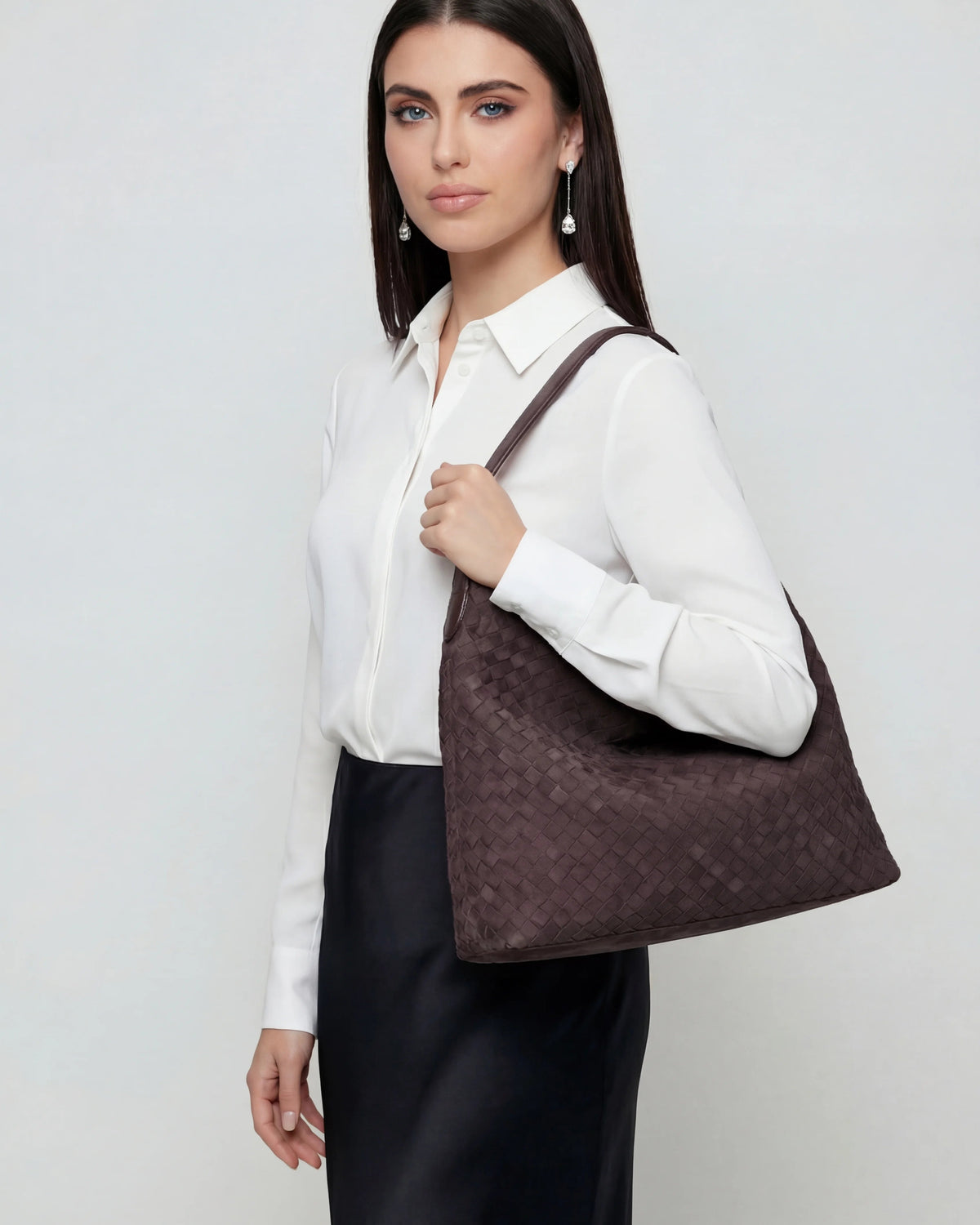 Elegant black suede tote bag by Lumina Wear featuring a spacious design and stylish hand-held carry option.