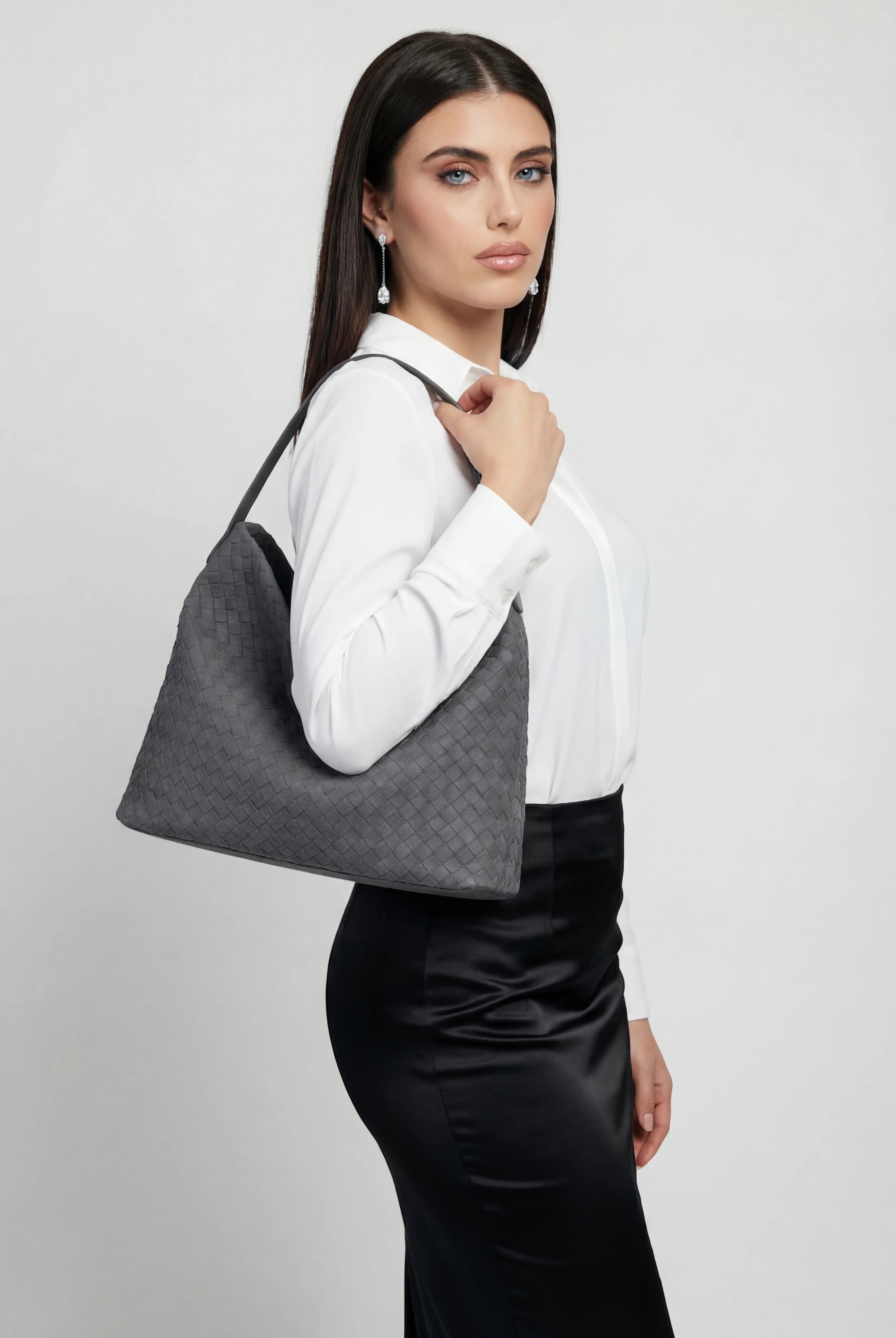 Elegant black suede tote bag by Lumina Wear, featuring a spacious design and stylish hand-held carry.