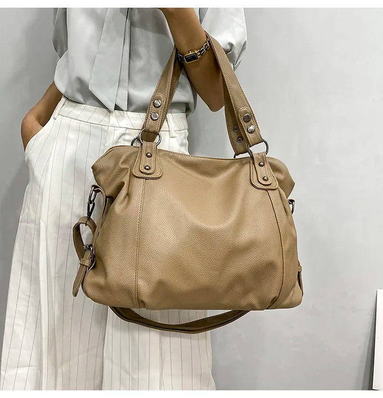 Elegant black tote bag from Lumina Wear, spacious handbag with sturdy handles, stylish for everyday use.