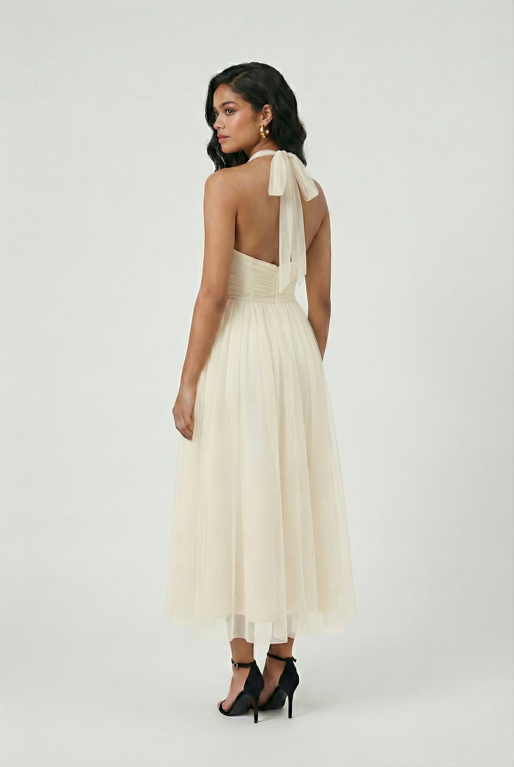 Elegant cream midi dress by Lumina Wear featuring a flowy design, perfect for stylish occasions.