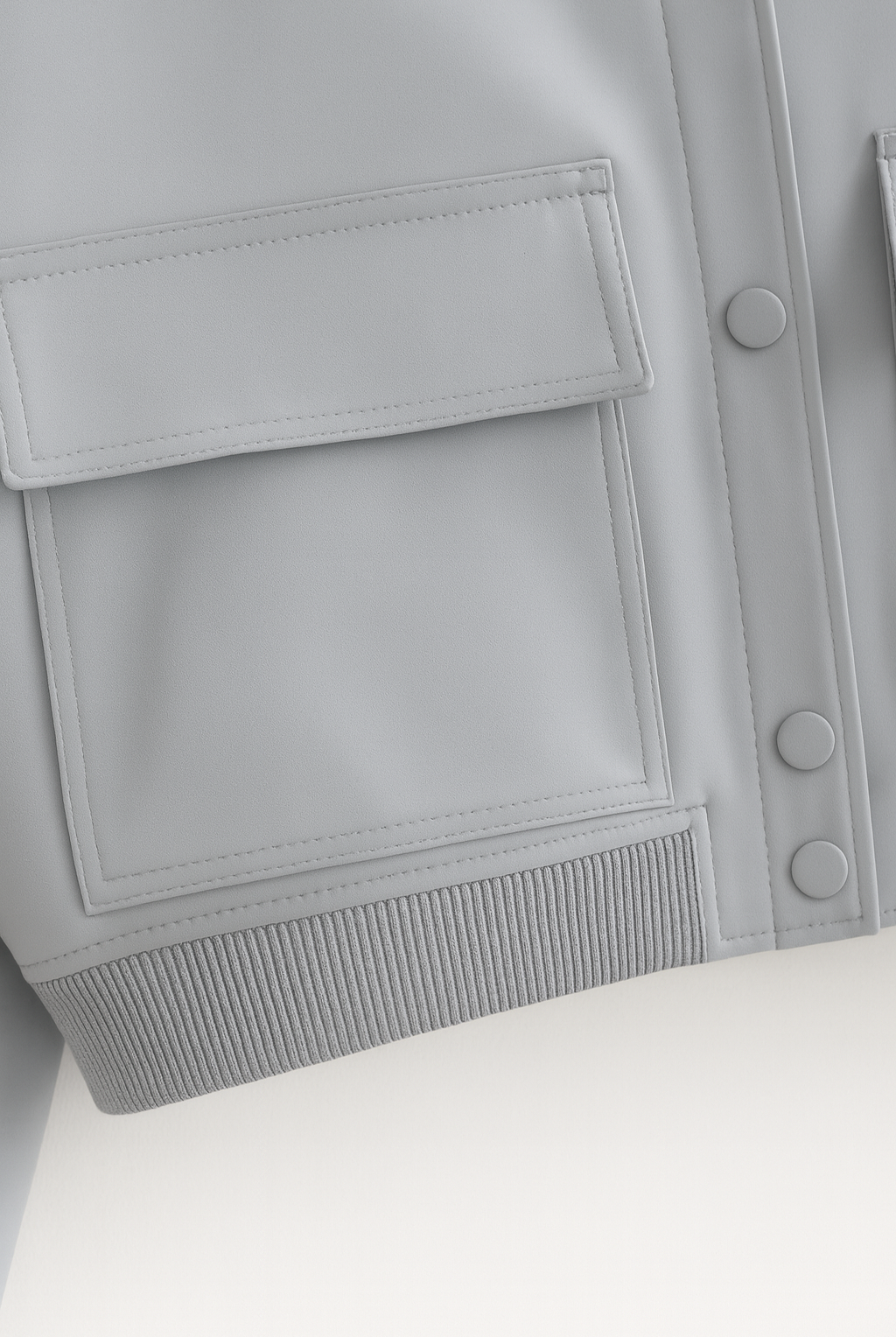 Elegant gray bomber jacket from Lumina Wear featuring a timeless design and stylish fit, shown in a close-up image.