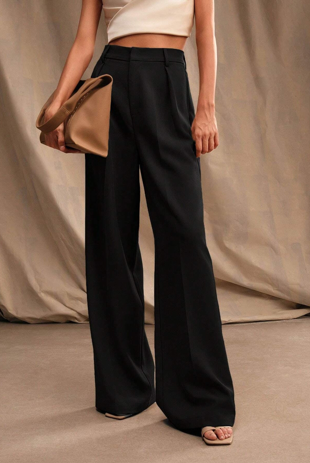 Black Victoria Lumina Wear high waist wide leg trousers, stylish and elegant with a flattering fit, shown on a model.