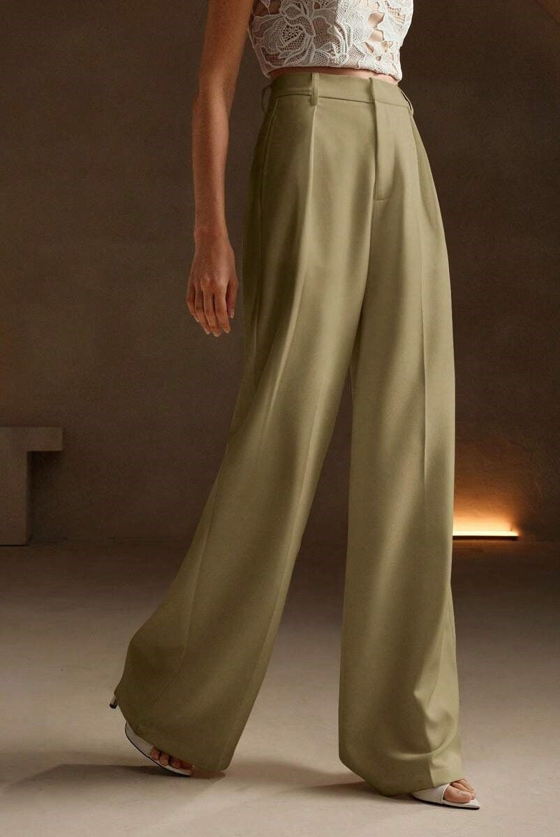 Black Victoria Lumina Wear high-waist wide-leg trousers laid flat, showcasing their elegant fit and tailored design.