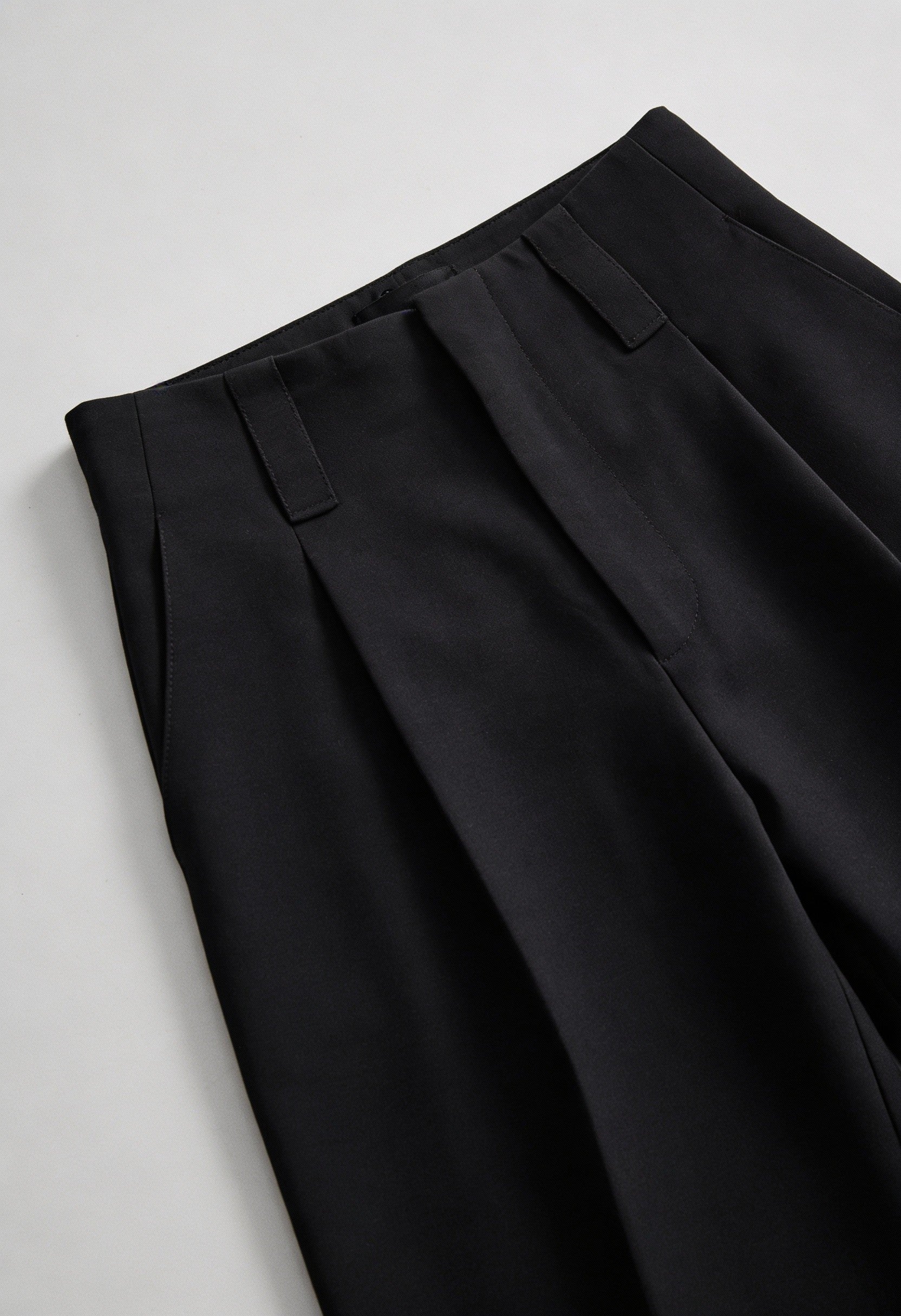 Elegant black high-waisted women's trousers with pleats by Lumina Wear, featuring a tailored fit and classic design.