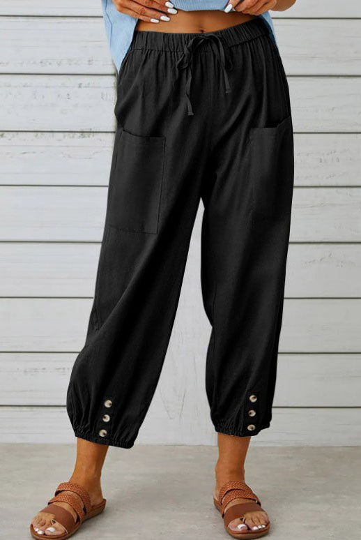 White Victoria Lumina Wear lightweight wide-leg trousers with a relaxed fit, shown on a model against a neutral background.