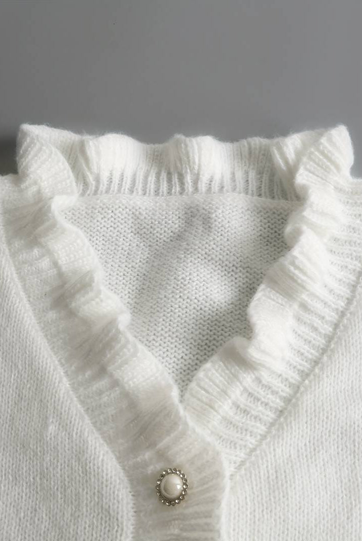 Elegant women's blouse by Lumina Wear featuring ruffle design and decorative buttons, displayed on a model.