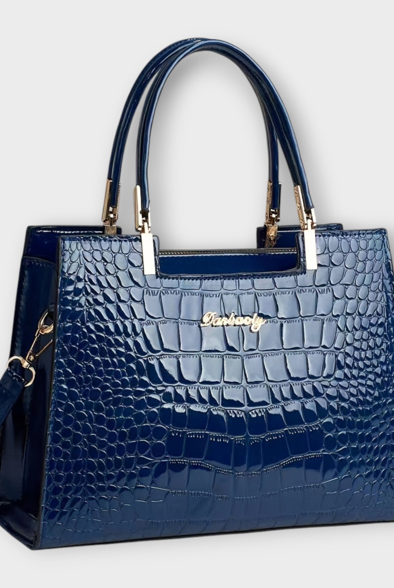 Black Lumina Victoria glossy crocodile pattern handbag with structured design, featuring elegant hand-stitched details.