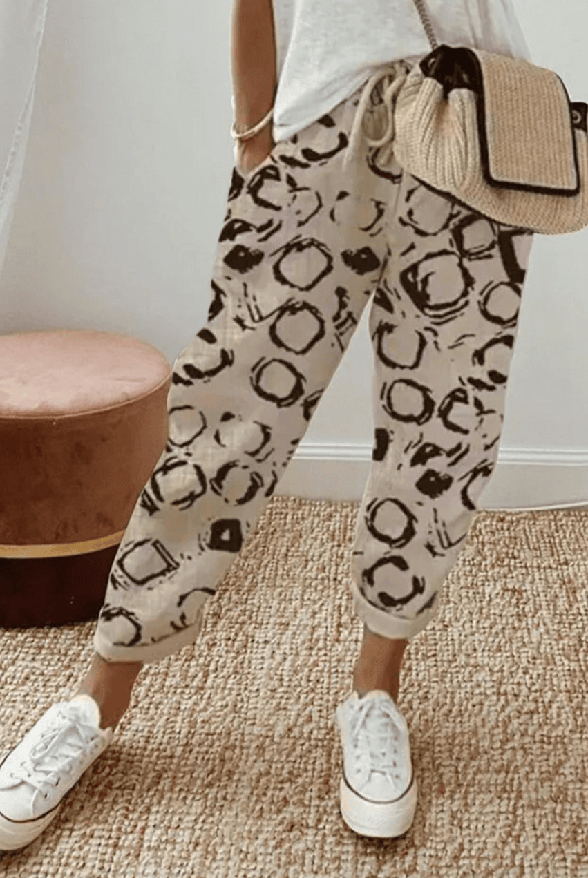 Lightweight beige casual trousers with relaxed fit from Lumina Wear, featuring a subtle printed pattern and comfortable design.