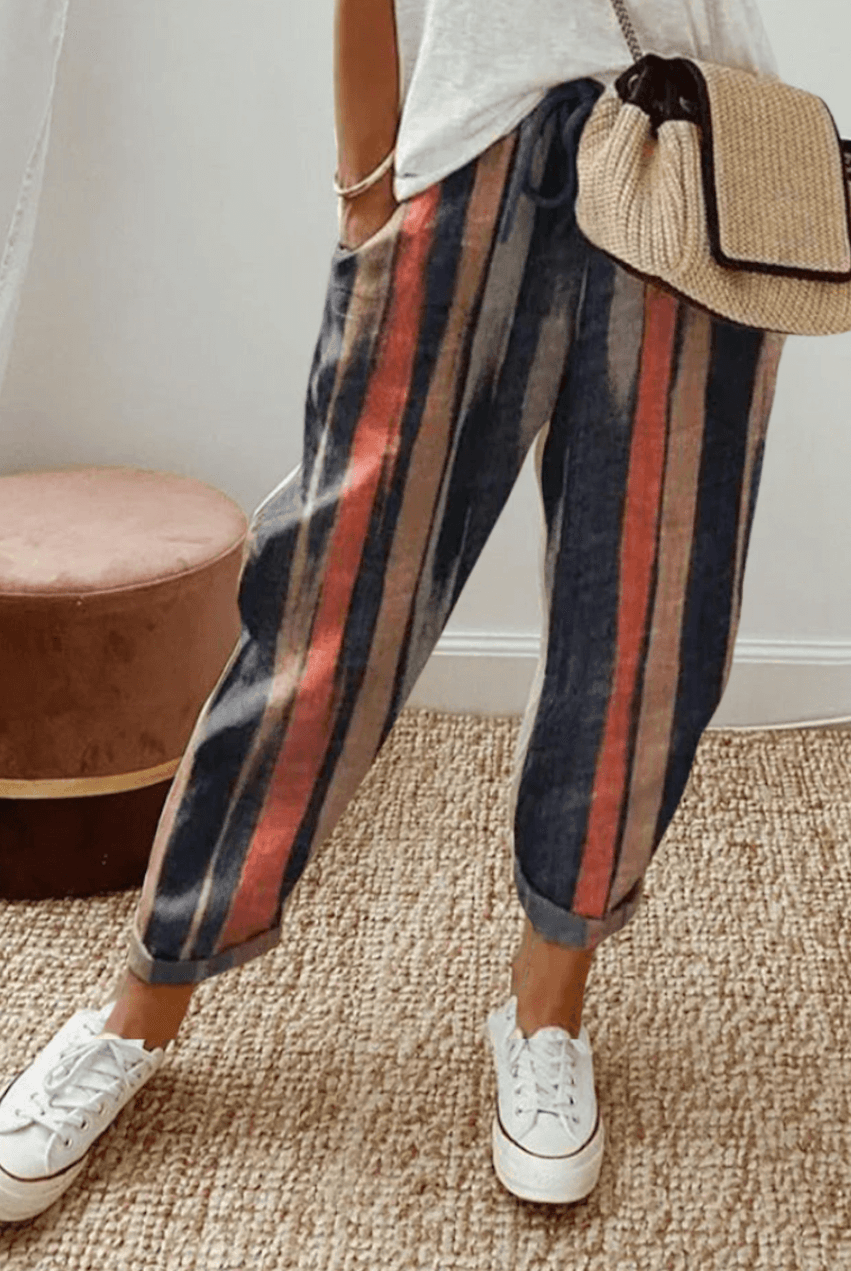 Lightweight beige casual trousers with relaxed fit from Lumina Wear, shown with subtle print details and comfortable design.