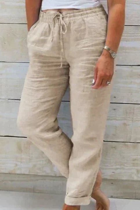 Lightweight beige summer trousers with elastic waist from Lumina Wear, shown as relaxed-fit pants ideal for warm weather.