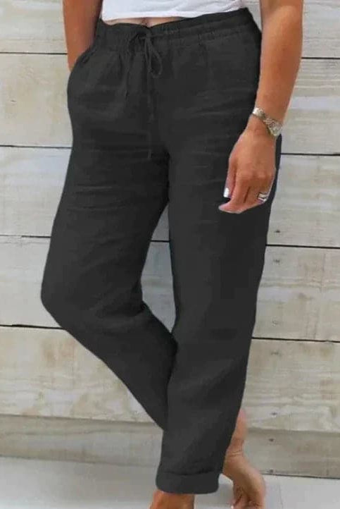 Lightweight beige summer trousers with elastic waist from Lumina Wear, shown flat with open front and relaxed fit.