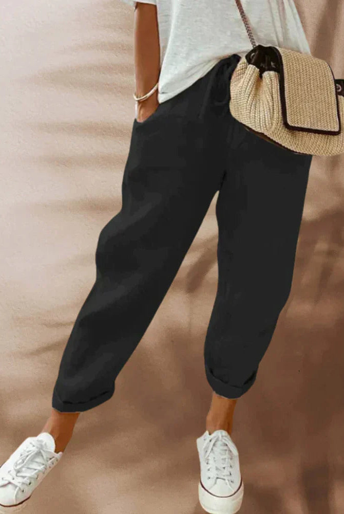 Lightweight black women's casual pants with elastic waist from Lumina Wear, displayed with beige background and relaxed fit.