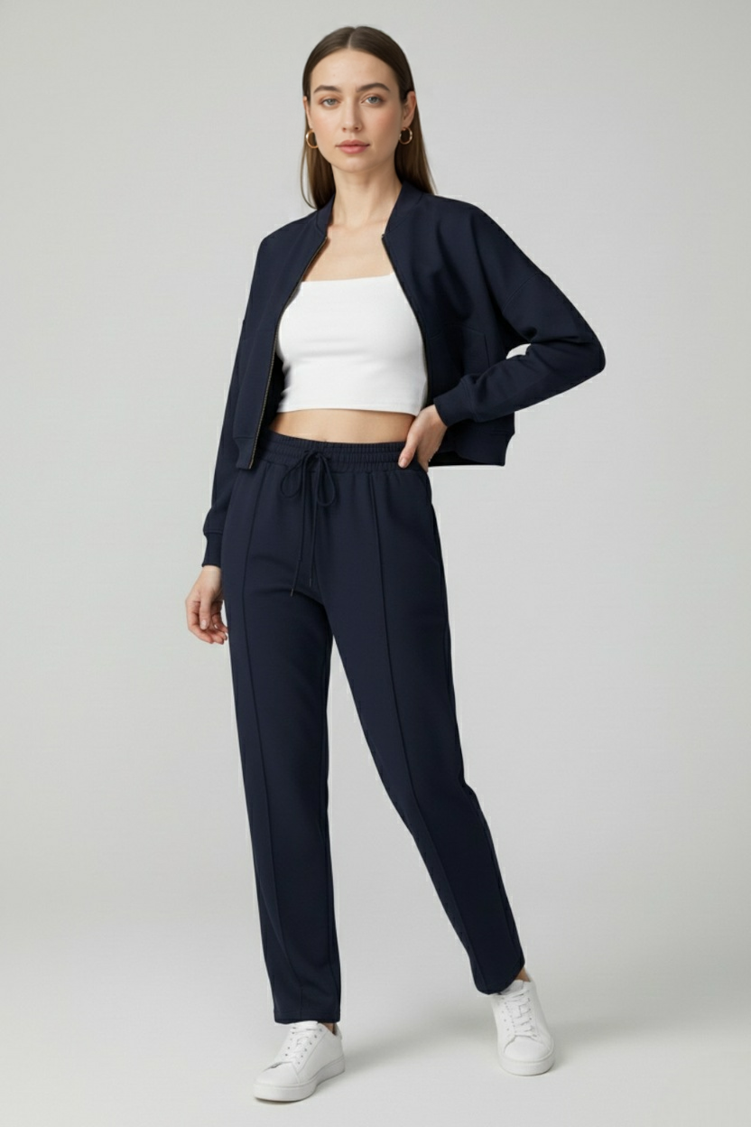 Victoria Lumina activewear set featuring dark blue relaxed fit sweatpants and sweatshirt with zipper accents.