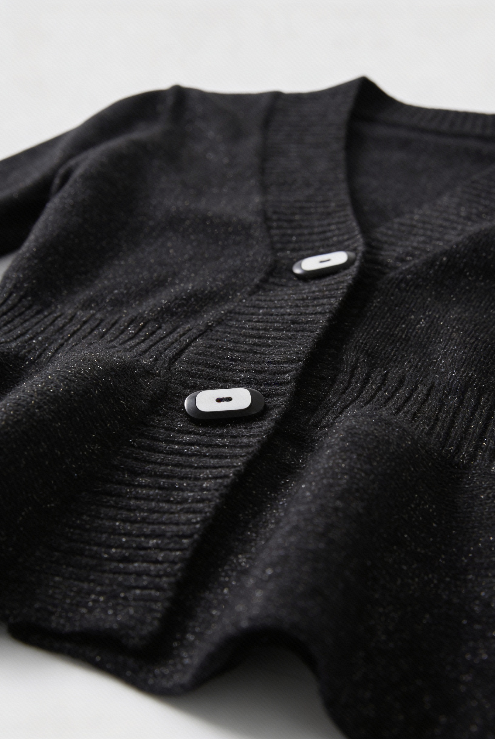 Lumina Wear Victoria black cardigan sweater with open front design, soft knit fabric, styled casually.