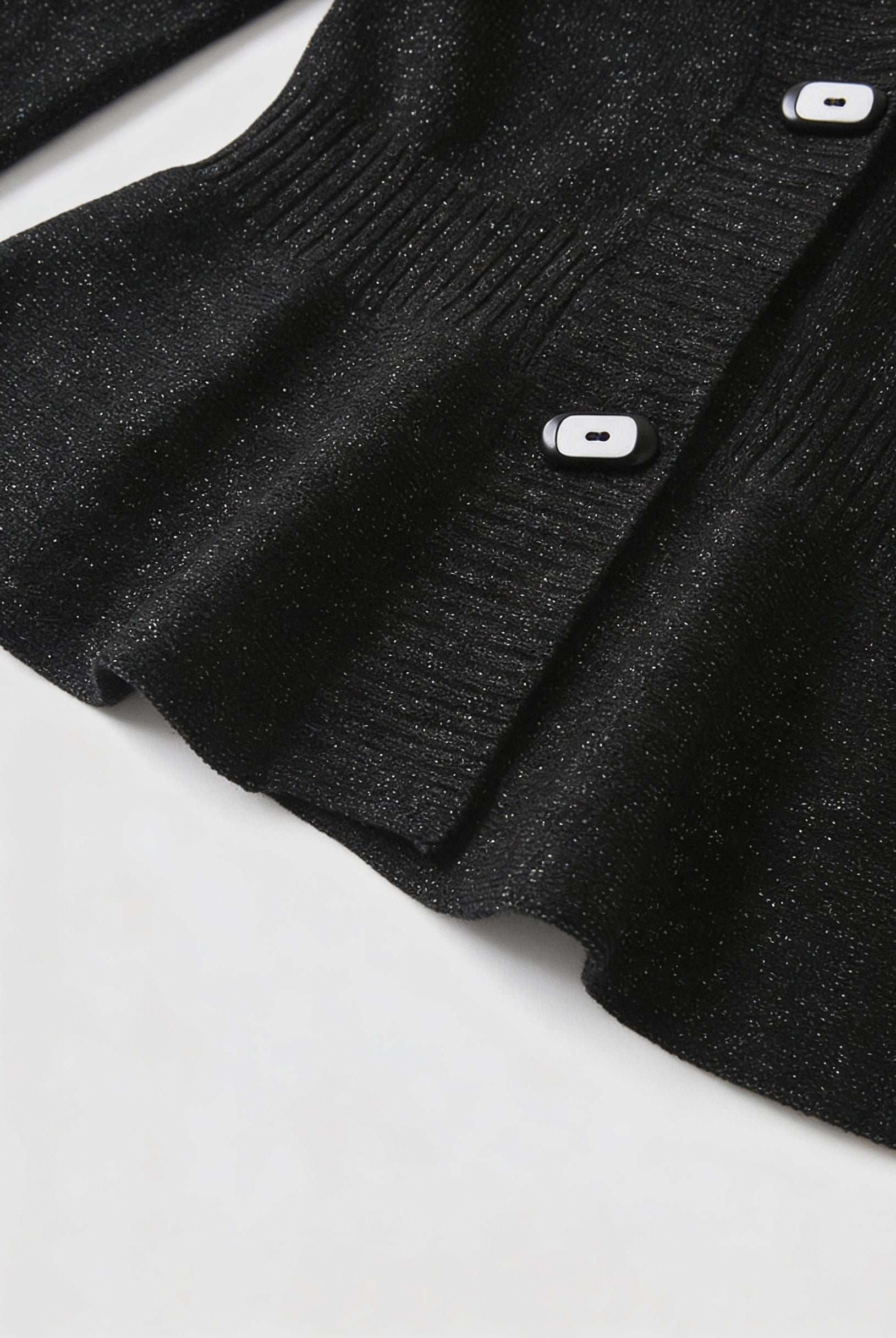 Victoria black cardigan sweater with open front design by Lumina Wear, shown on a hanger with a relaxed fit and soft knit fabric.
