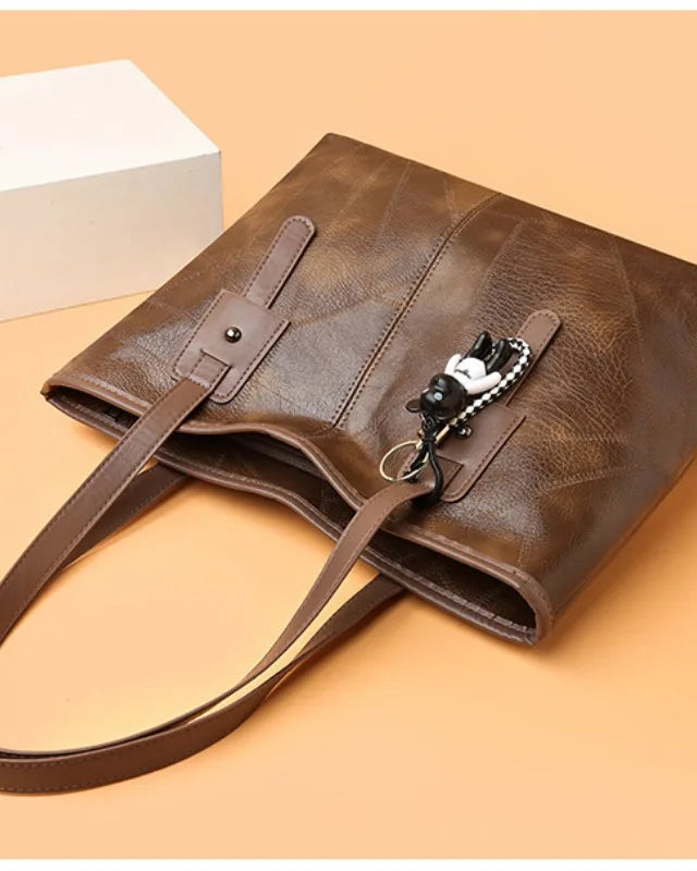 Lumina Wear Victoria vintage-inspired beige tote bag with spacious interior and keychain accent, stylish handbag for everyday use.