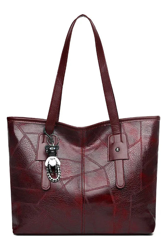 Vintage-inspired Lumina Victoria tote bag in khaki with spacious interior and keychain accent, ideal for stylish everyday use.