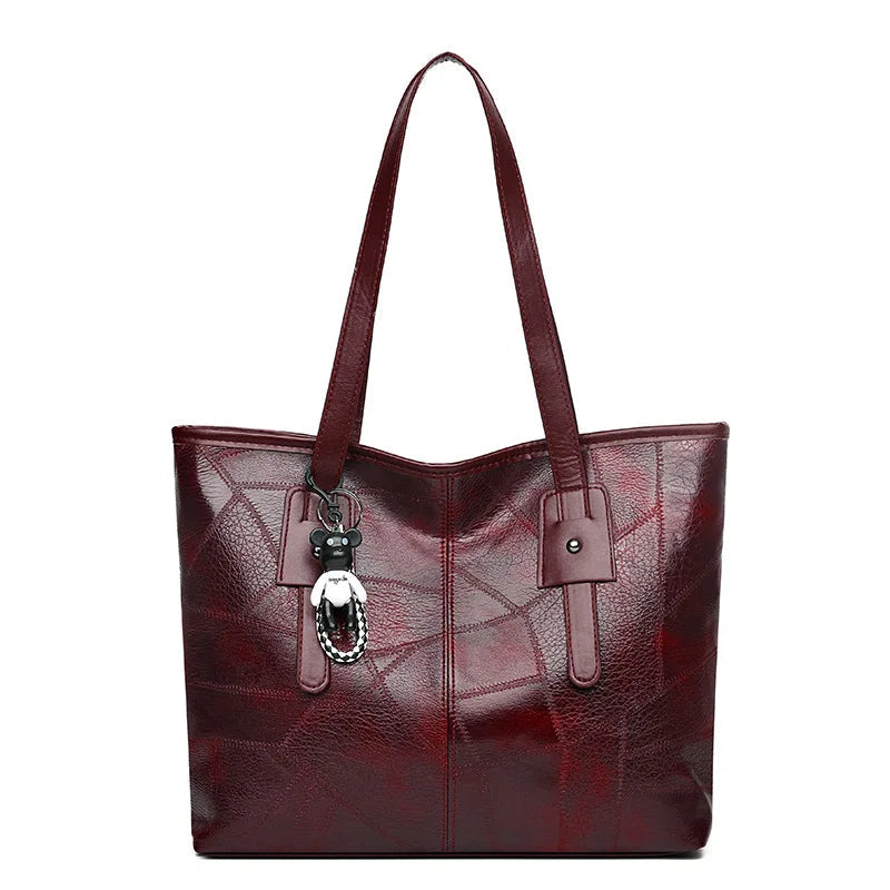 Vintage-inspired Lumina Victoria tote bag in khaki with spacious interior and keychain accent, ideal for stylish everyday use.