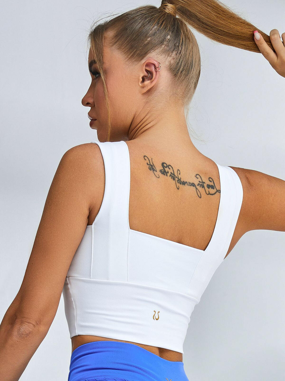 White Lumina Vancouver sports bra with wide shoulder straps, designed for comfortable support during workouts.