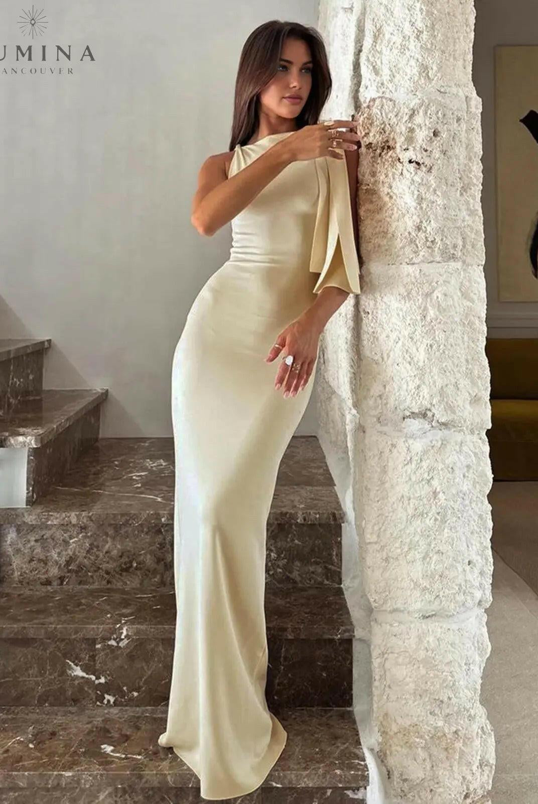 Yasmine off-white knotted maxi dress by Lumina Wear, flowing fabric with a knotted detail at the waist, full-length dress on a model.