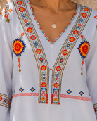 Bohemian embroidered summer blouse with V-neck by Lumina Wear, featuring colorful floral embroidery and relaxed fit.