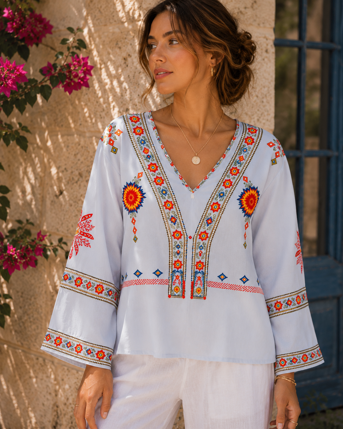 Lumina Wear Penelope bohemian embroidered summer blouse with V-neck, featuring colorful floral embroidery and lightweight fabric.