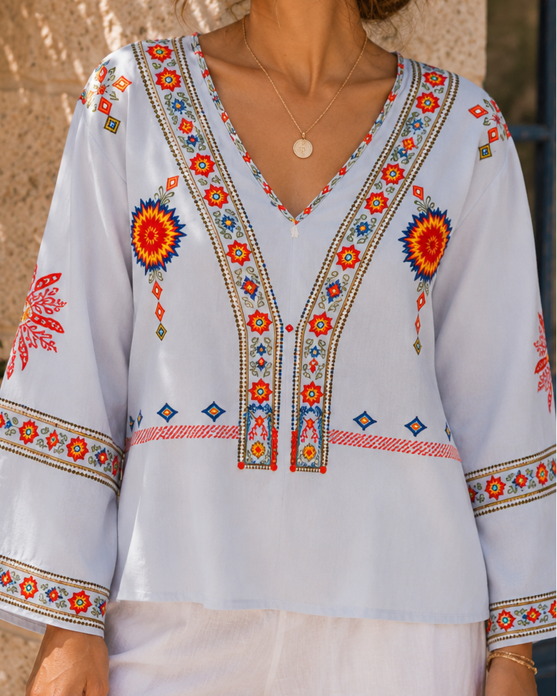 Bohemian embroidered summer blouse with V-neck from Lumina Wear, featuring colorful embroidery and lightweight fabric.