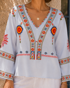 Bohemian embroidered summer blouse with V-neck from Lumina Wear, featuring colorful embroidery and lightweight fabric.