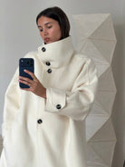 Elegant Lumina Wear Amaya longline coat with structured design and high-neck style, displayed on a mannequin.