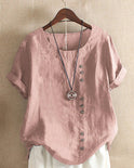 Light beige Beatrice summer blouse by Lumina Wear featuring relaxed fit and button details, displayed on a hanger.