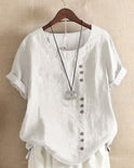 Beatrice relaxed summer blouse with button detail from Lumina Wear, lightweight fabric and casual fit, shown on a hanger.