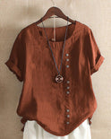 Light blue Beatrice summer blouse by Lumina Wear featuring relaxed fit and button detail, displayed on a hanger.