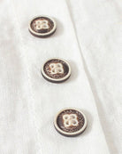 Light beige Lumina Wear Beatrice relaxed summer blouse with button detail, featuring a loose fit and breathable fabric.
