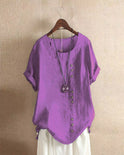 Light beige relaxed summer blouse with button details from Lumina Wear, featuring a comfortable fit and casual style.