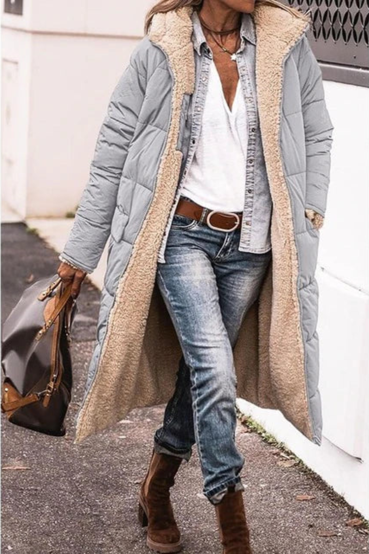 Elegant Lumina Wear Carina reversible long winter coat for women, showcasing cozy warmth and stylish design in a winter setting.